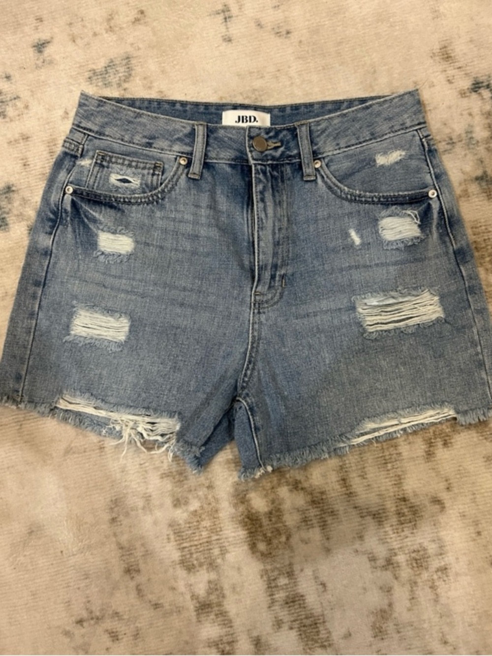 High-Rise Distressed Denim Shorts in Light Blue